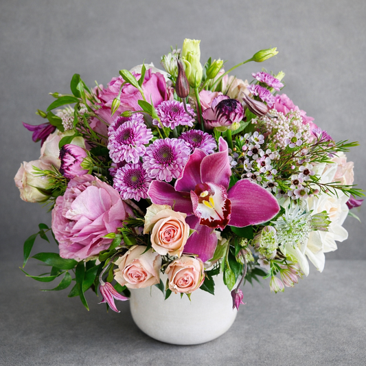 Bouquet of flowers with pink and purple colors in a white vase