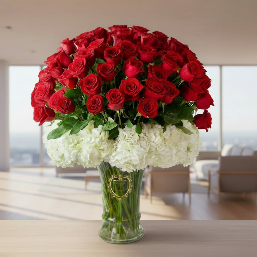 Bouquet of red roses and white hydrangeas in a clear vase background
