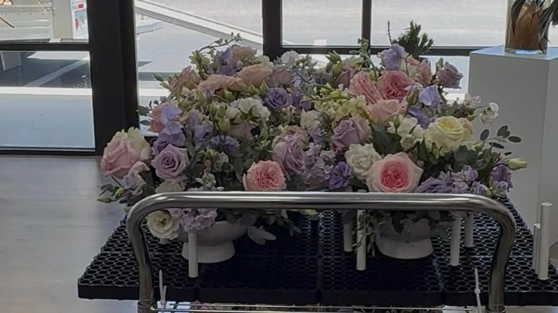 Two carts filled with beautiful floral arrangements inside a store.