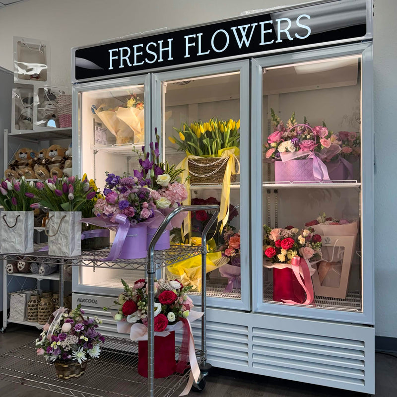 Fresh floral arrangements displayed in a professional florist cooler