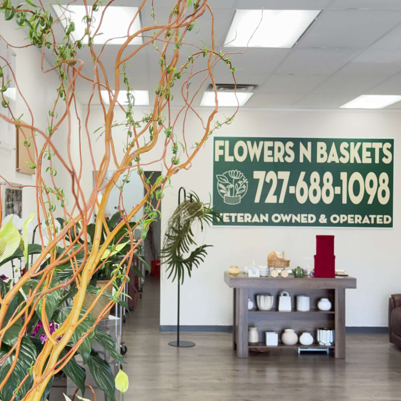 A warm and inviting local floral shop with a sign that says Flowers N Baskets.