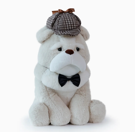 Plush toy bulldog wearing a checkered hat and black bow tie 