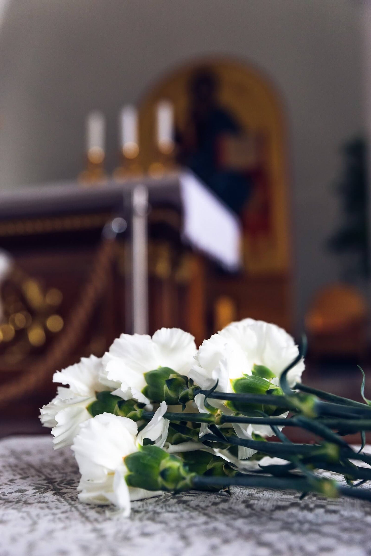 White flowers on a textured surface with a blurred background