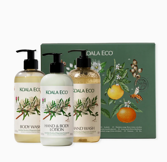 Koala Eco skincare products including body wash, hand & body lotion, and hand wash with a branded box in the background.