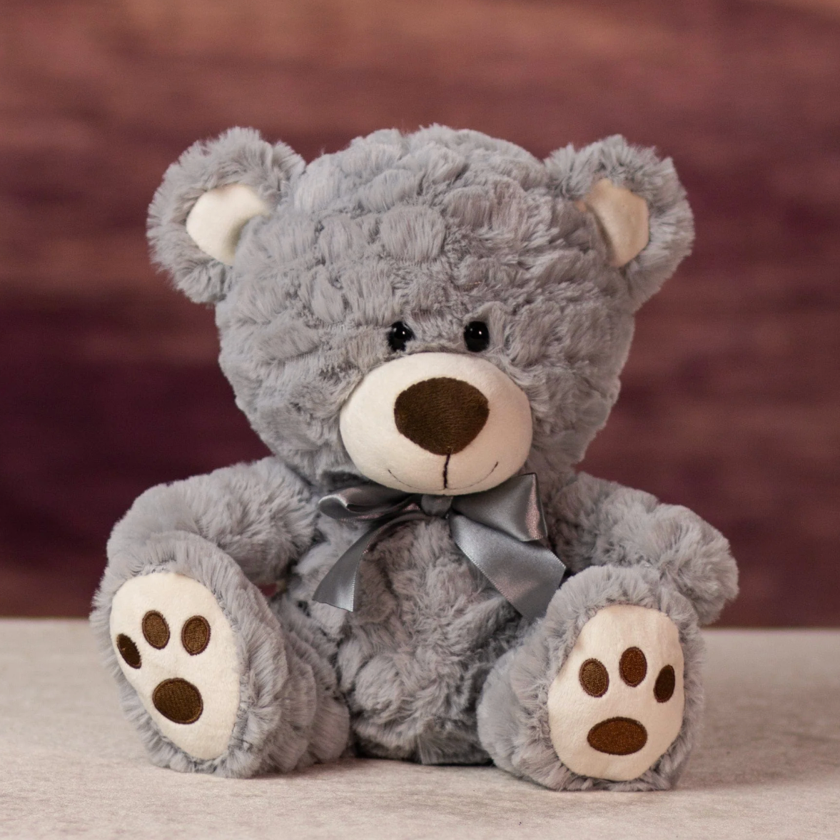 Gray teddy bear with a bow tie 