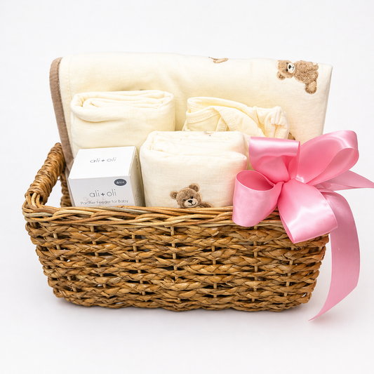 Gift basket with blanket, and pink bow on a white background