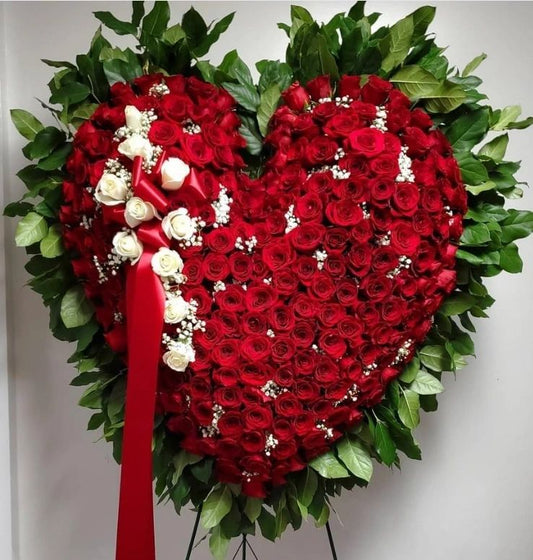 Heart-shaped funeral flower arrangement with red roses and greenery – sympathy tribute Tampa Bay