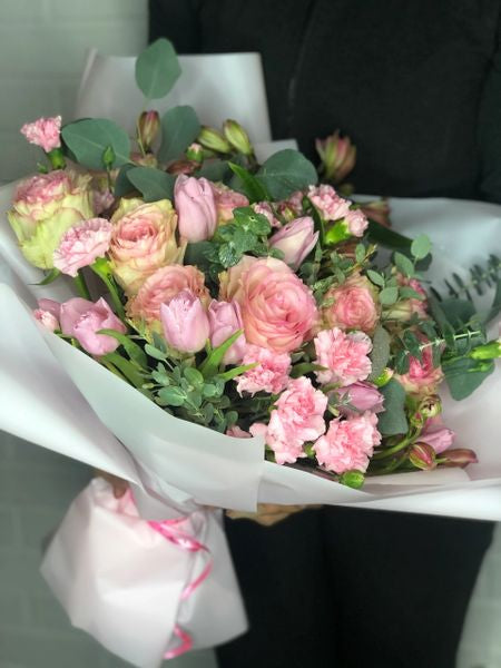 Bouquet of pink flowers wrapped in pink paper 
